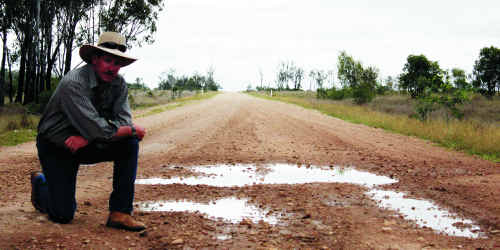 Peter Quinn inspects the damage on May Downs Rd. Peter Quinn inspects the damage on May Downs Rd.
